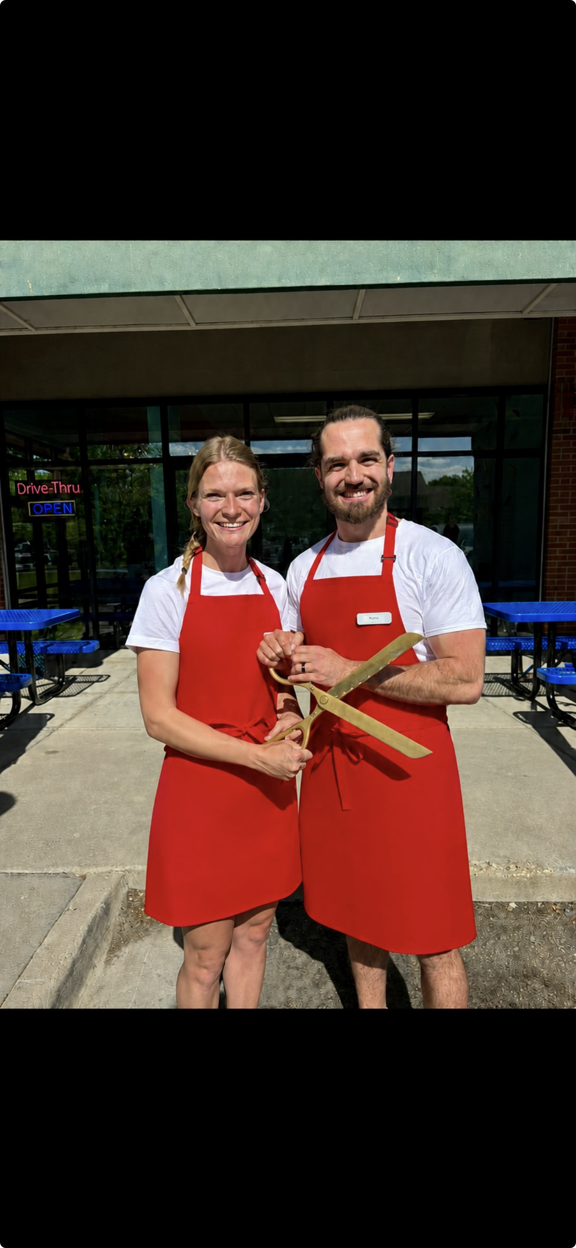 Nate and Morgan outside Scoops on the Corner at the ribbon cutting