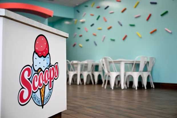 Inside Scoops on the Corner with colorful sprinkle wall and seating